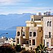 Typical Aqaba buildings on the foreground. the Gulf of Aqaba and mountains on the background