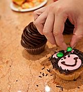 Woman Decorating her Cupcake as a Bear