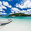 A few boats on the clear water of Kabira Bay in Ishigaki, Japan