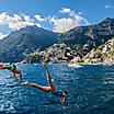 Italy Naples Positano Couple Jumping in Ocean