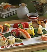 Plate of fresh assorted sushi and sashimi rolls.