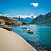 Coastal road with docks docked in the bay in Kotor, Montenegro