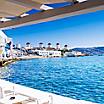 View of the famous Mykonos windmills as seen from a restaurant in Mykonos, Greece