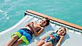 Coco Beach Club Floating Cabana Kids Laying on Hammock, Perfect Day at Coco Cay